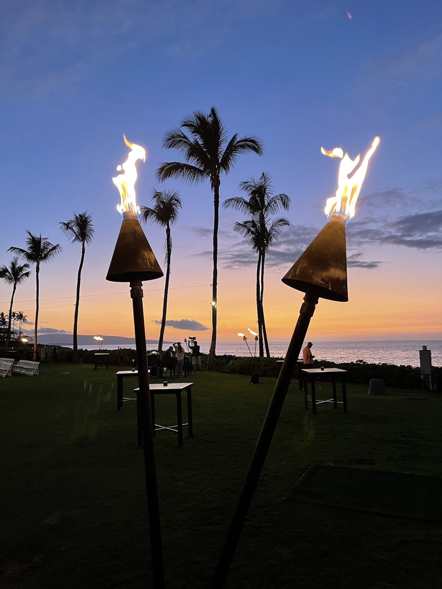 Tiki Torches at sunset on the Molokini Garden Lawn for the 2023 Maui Songwriter's Festival.